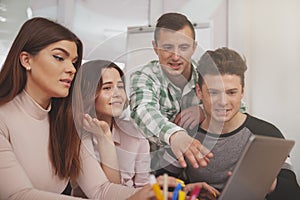 Group of young people studying together at college classroom