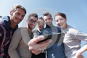 Group of young people taking a selfie.