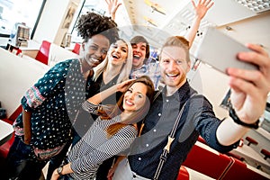 Group of young people taking selfie with mobile phone