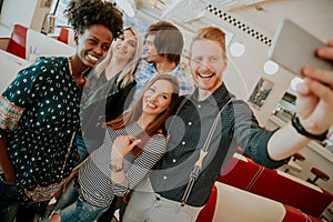 Group of young people taking selfie with mobile phone