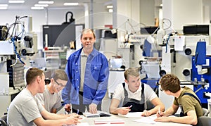 Group of young people in technical vocational training with teacher