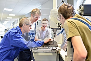 Group of young people in technical vocational training with teacher