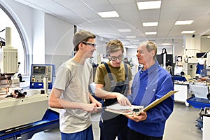 Group of young people in technical vocational training with teacher