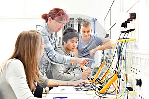 Group of young people in technical vocational training with teacher