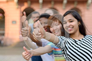 Group of young people with thumbs up