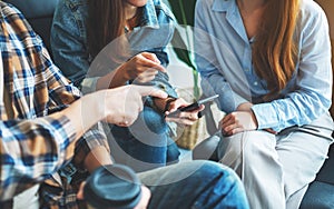 Group of young people using phone and talking together