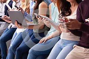 Group Of Young People Using Various Electronic Gadgets