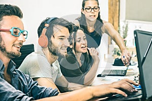 Group of young people working with computer in startup office photo