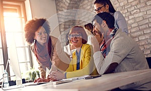 Group of young people working together on computer