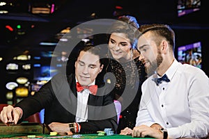 Beautiful and rich people playing roulette in the casino