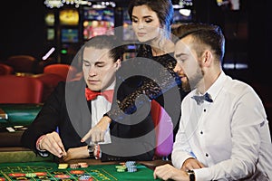 Beautiful and rich people playing roulette in the casino