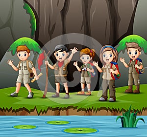 Group of young scout girls and boys in nature