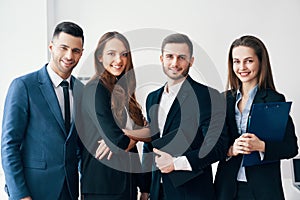 Group of young and smiling business people in modern office