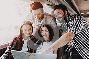 Group of Young Smiling People Holding Paper Map