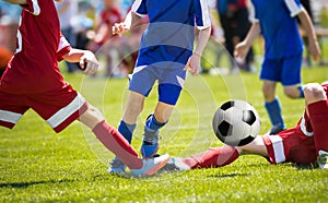 A group of young soccer players runnng the ball. Footballer dribbling drills and tackle attempt photo