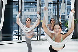 group of young sportswomen stretching with