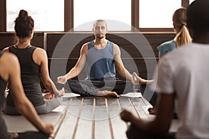 Group of young sporty people in Easy Seat pose