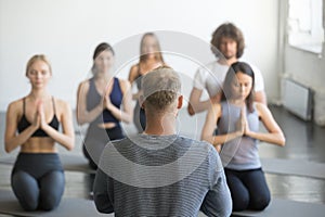 Group of young sporty people in seiza pose