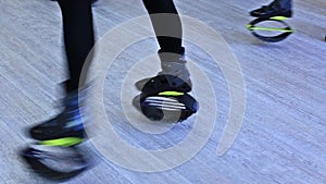 Group of young sporty women doing fitnes exercises with kangoo jumps shoes in a gym.