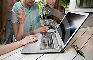 Group of young student using laptop outdoor