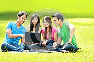 Group of young student using laptop outdoor