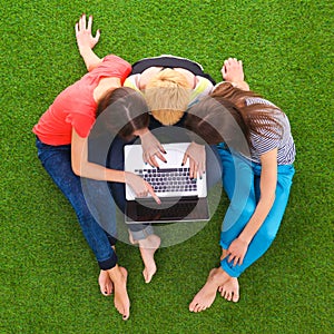 Group of young student using laptop together