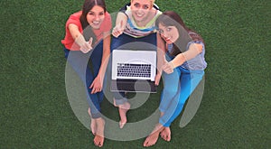 Group of young student using laptop together