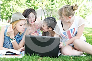 Group of young student using laptop together