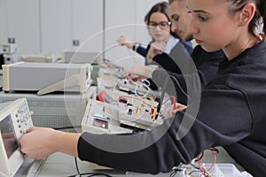 Group of young students in technical vocational training with teacher, the lesson in technical college. Education and technology