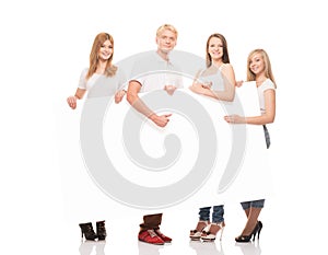 Group of young, stylish and happy teenagers with a banner