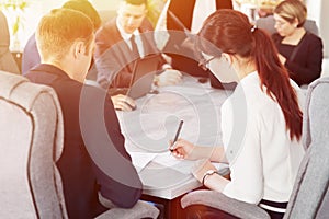 Group of young successful businessmen lawyers communicating together in a conference room while working on a project