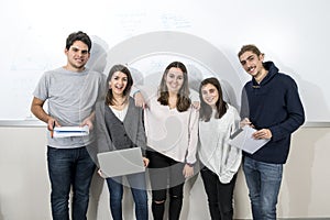 Group of young teen University students posing together standing