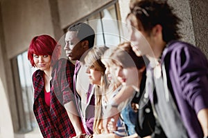 Group of young teens staring into distance.