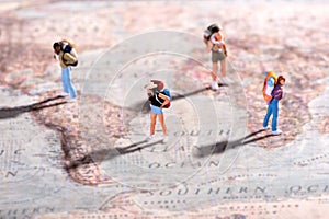 Group of young travellers on a world map photo