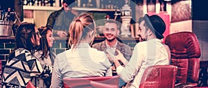 Group of young trendy friends chatting and laughing together inside cocktail fashion bar - Cheerful people having fun doing pre