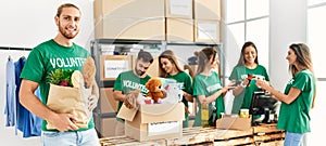 Group of young volunteers working at charity center