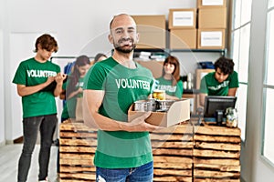 Group of young volunteers working at charity center