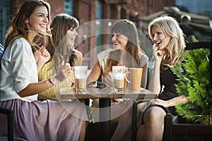 Group of young women drinking coffee photo