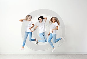 Group of young women in jeans jumping