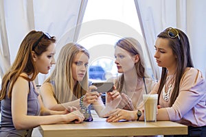 Group Of Young Women Sitting Around Table Eating Dessert