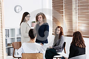 Group of young women talking sitting in a circle. Psychological support concept