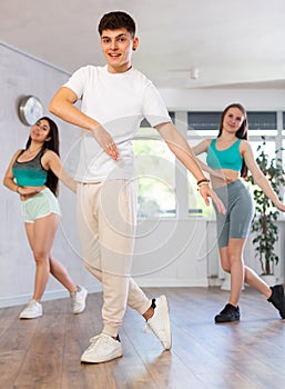 Group of young women and young guy dance contemporary