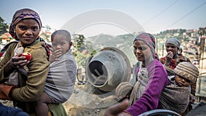 Group of young working mums carry infant on their back smile while doing work routine at construction site at Shimla district, Him