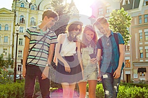 Group of youth is having fun, happy teenagers friends walking, talking enjoying day in the city.