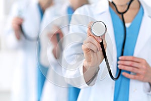 Groupe of medicine doctors hold stethoscope head closeup. Physicians ready to examine and help patient. Medical help and