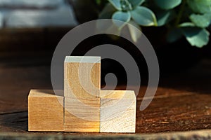 Groupped wooden square blocks on dark wooden table