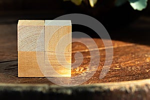 Groupped wooden square blocks on dark wooden table