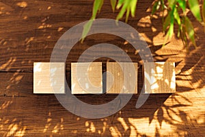 Groupped wooden square blocks on dark wooden table