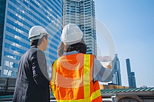 Groups of Construction engineers or workers with Team Construction asian worker. Use blueprint on Construction Site. real estate