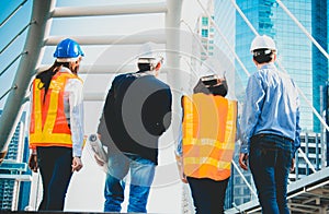 Groups of Construction engineers or workers with Team Construction asian worker. Use blueprint on Construction Site. real estate